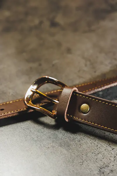 Handmade leather belt with a golden buckle. Belt for trousers