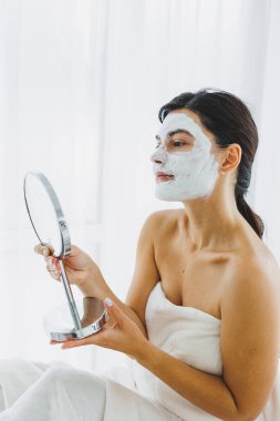 Güzellik salonundaki müşterinizin yüzündeki maske. Cilt temizleme ve nemlendirici konsept. Yüz bakımı.