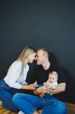 Anne, baba ve yeni doğan oğul evde oynuyorlar. Çocuklu mutlu bir aile..