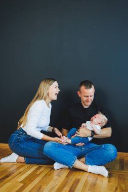 Anne, baba ve yeni doğan oğul evde oynuyorlar. Çocuklu mutlu bir aile..