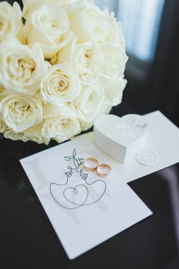 Gelinin aksesuarları. Gelin için düğün ayakkabıları. Alyansların yanındaki yüksek topuklu ayakkabılar, düğün mücevherleri..