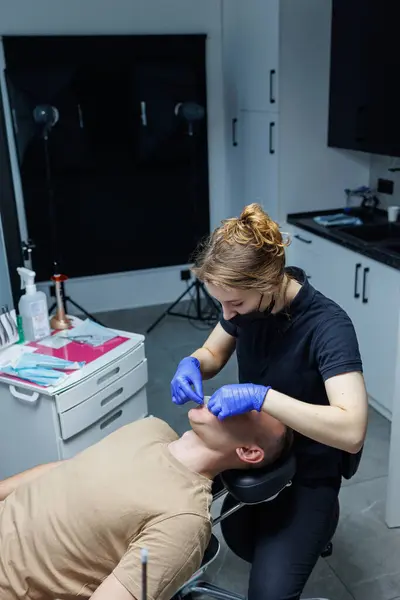 stock image Modern dental equipment. The orthodontist installs the bracket system on the patient's teeth, dental treatment. Dental chair.