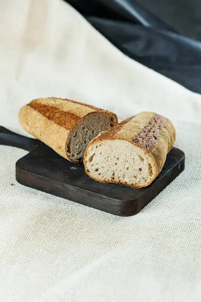 stock image Freshly baked rye bread on a mixture of whole grain, rye and wheat flour. Fresh homemade bread. Craft pastries