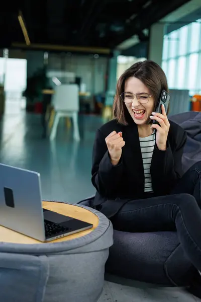 stock image Smiling business woman, company employee, working holding laptop while sitting in modern office. Modern business woman working online.