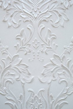 Beyaz bir duvarda desen var. Duvardaki desenlerin dokusu.