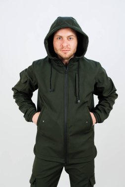 Ekstra sıcaklık ve soğuğa karşı koruma sağlayan yeşil bir ceket giyen bir adam.
