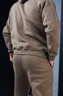 Rahat, rahat kahverengi bir eşofman giyen şık bir birey. Günlük kıyafet için ideal.