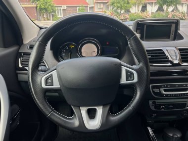 Zarif bir direksiyon simidi ve yenilikçi işlevleri vurgulayan gelişmiş bir gösterge paneli içeren bir iç mekanın modern tasarımını keşfedin