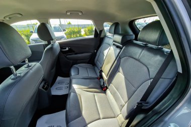 Yumuşak gri koltuklar modern bir arabanın arka koltuğunda rahatlamaya davetiye çıkarır. Aile gezileri ya da günlük geziler için birebirdir. Parlak güneş ışığı içeri süzülür, sıcak atmosferi güçlendirir..