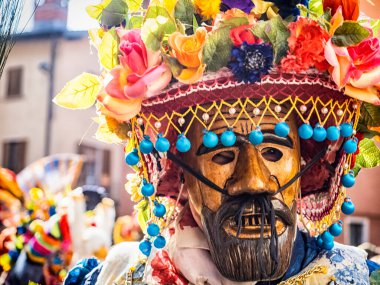 Shignano (Italy) 21/02/2023: The carnival of Schignano parade is one of the most famous traditional carnivals of north Italy with typical wood masks and performer that entertain the visitors .