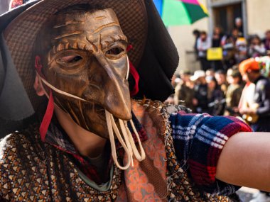Shignano (Italy) 21/02/2023: The carnival of Schignano parade is one of the most famous traditional carnivals of north Italy with typical wood masks and performer that entertain the visitors .