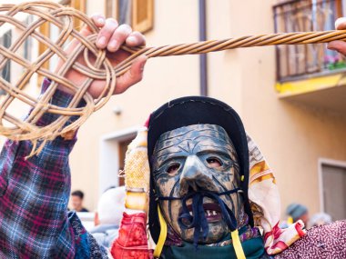 Shignano (Italy) 21/02/2023: The carnival of Schignano parade is one of the most famous traditional carnivals of north Italy with typical wood masks and performer that entertain the visitors .