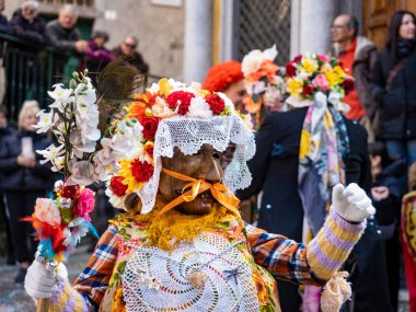 Shignano (Italy) 21/02/2023: The carnival of Schignano parade is one of the most famous traditional carnivals of north Italy with typical wood masks and performer that entertain the visitors .
