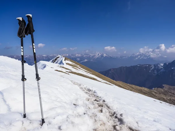 Trekking poles on an alpine trail in the italian alps