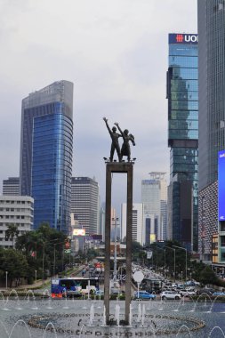 Jakarta, 19 Şubat 2023; Karşılama Anıtı, Endonezya Roundabout Oteli 'nin ortasında ellerinde çiçekler tutan ve el sallayan bir çift insanın heykeli.