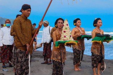 Parang Tritis Beach, Yogyakarta 7 June 2022: Annual Festival of the Sea Offering. The community around Parangtris beach holds a traditional celebration called Labuhan Bhakti Pisungsung Jaladri. clipart