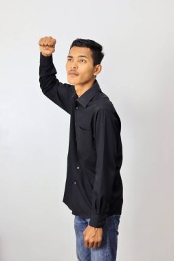 Asian man wearing black shirt and showing Fist up isolated on white background clipart