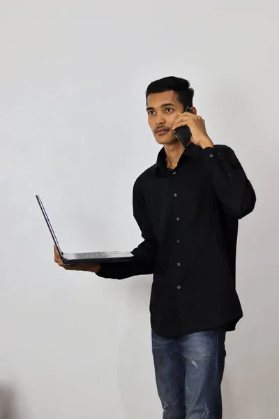 Jeune Homme Parlant Sur Téléphone Portable Tout Utilisant Ordinateur Portable — Photo