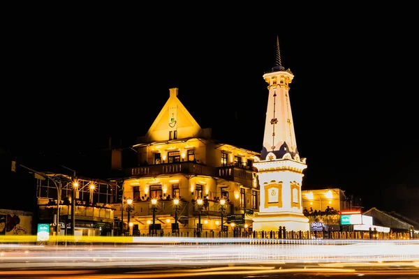 Yogyakarta, Endonezya - 14 Ocak 2024: Motosiklet ve arabaların hafif efektleriyle geceleyin Tugu Jogja. Tugu Yogyakarta 'da yavaş çekim tekniği.