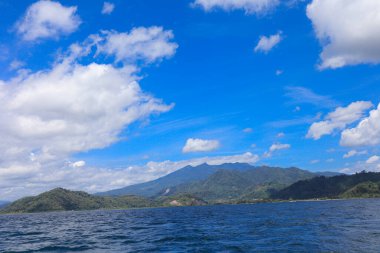 Sea view of Pahawang beach with mountains and scenic sky clipart