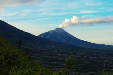 Merapi Dağı 'nın manzarası sabahleyin Andong Dağı' ndan çıkan dumanı püskürtüyor.                