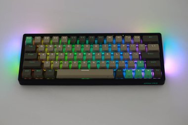 Lampung, January 23 2025, A black mechanical keyboard with grey and green keycaps is shown with RGB lighting clipart