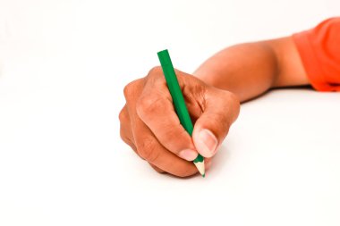 Yeşil bir kalem tutan ve beyaz bir yüzeye yazı yazan bir elin yakın çekimi