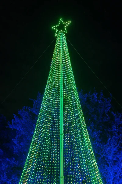 Lighted Christmas tree with moving lights on a light show.