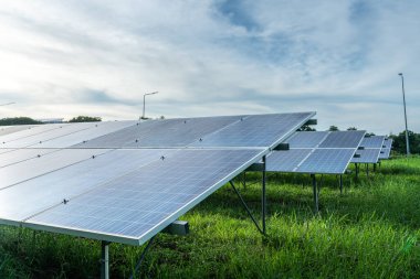 Fotovoltaik güneş enerjisi paneli dramatik gün batımı mavi gökyüzü arkaplanı, yeşil temiz Alternatif enerji kavramı.