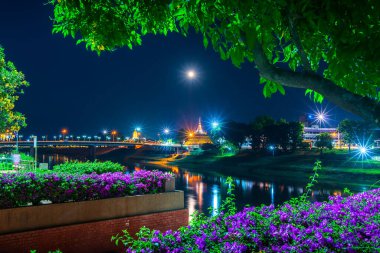 Naresuan Köprüsü 'nde ışık ve Wat Ratchaburana' dan Chedi ve Prang Wat Phra Si Rattana Mahathat da Nan Nehri 'nde konuşma dilinde ve parkta ve Tayland, Phitsanulok' ta gece dolunayda.