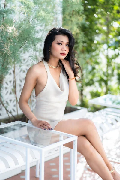 Portrait beautiful asian freelance Success people business woman fashion model in summer white sleeveless dress and coffee in cup in coffee shop.