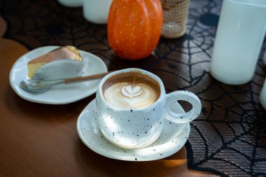 Sütlü sütlü sütlü sütlü sütlü sıcak kahve ve kahveli ev yapımı cheesecake. Cadılar Bayramı Cadılar Bayramı Cadılar Bayramı arkaplanda Cadılar Bayramı teması..