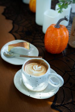 Sütlü sütlü sütlü sütlü sütlü sıcak kahve ve kahveli ev yapımı cheesecake. Cadılar Bayramı Cadılar Bayramı Cadılar Bayramı arkaplanda Cadılar Bayramı teması..