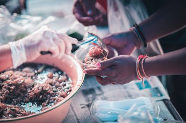 Hands of hungry people asking for free food from volunteers : humanitarian aid concept