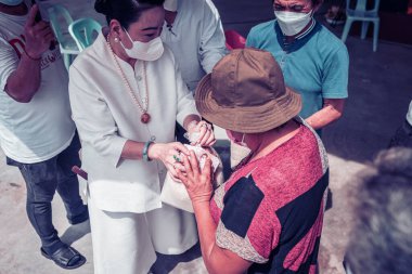 Chiangmai, Tayland - 7 Ağustos 2022: Hayırseverler ve gönüllüler fakir ve aç köylülere pirinç, kuru yiyecek ve para bağışlamak için gelirler.