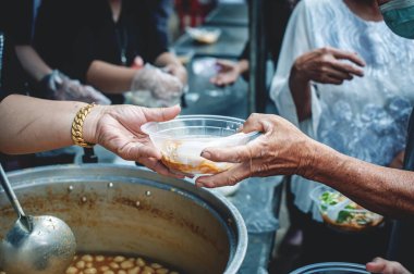 concept of free food serving : Volunteers serving food for poor people clipart