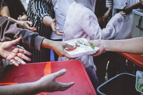 concept of free food serving : Volunteers serving food for poor people