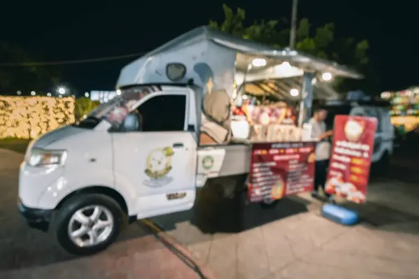 Blurred image of a street food truck at night