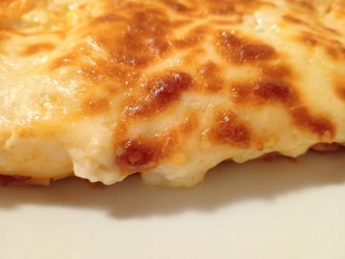 Eti kıyma ve beşameli lazanya yakın çekim. Emilian mutfağından bir çeşit yemek. Arka plan olarak İtalyan yemekleri.