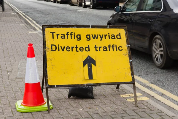 Bilingual temporary traffic diversion sign in English and Welsh at road and pavement works in Wales United Kingdom