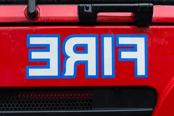 The word Fire in reverse on the front of a fire engine