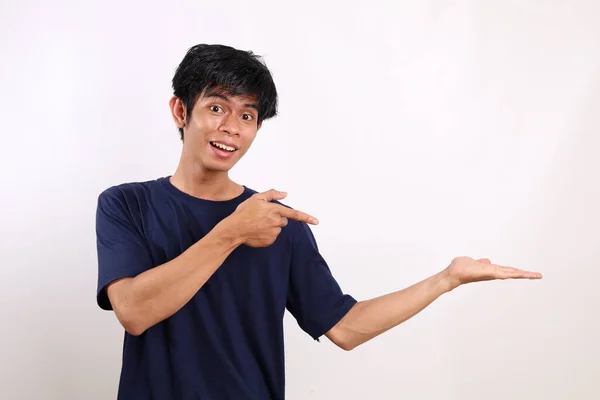 Happy Asian Young Man Standing While Pointing — Stok Foto