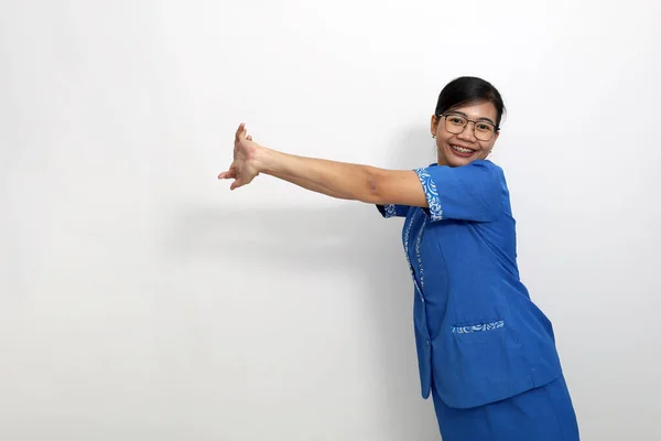 Young asian employee standing while stretching her hand or arm. Isolated on white background