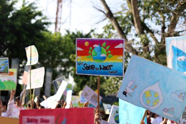 People with placards and posters on global strike for climate change. Save water campaign