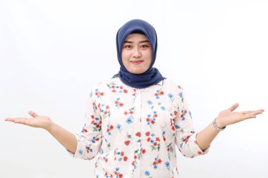 Happy asian veiled woman standing while presenting both sides. Isolated on white background