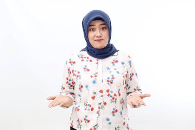 Happy asian veiled woman standing while presenting something on her hands. Isolated on white background