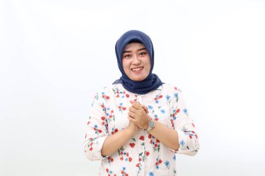 Asian veiled woman standing while showing welcoming or greeting hand gesture. Isolated on white
