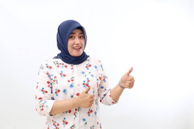 Happy Asian veiled woman standing while showing thumbs up. Isolated on white