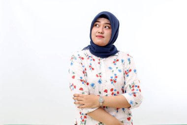 Asian veiled woman standing while looking up. Isolated on white background