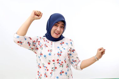 Satisfied asian muslim woman standing while celebrate his success. Isolated on white